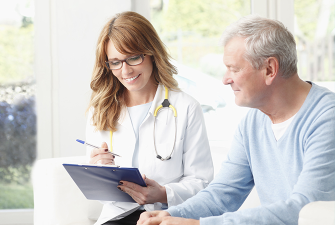 A physician and patient go over paperwork together.